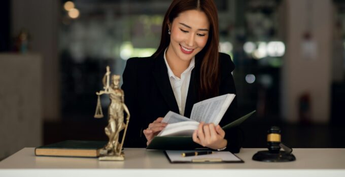 Attractive lawyer in office Business woman and lawyers discussing contract papers with brass scale o